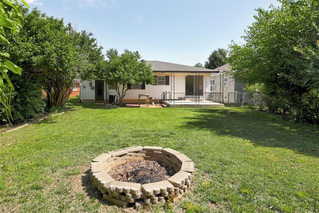 520 SE 47th St, Oklahoma City, OK 73129 - back of property featuring a fire pit and a patio