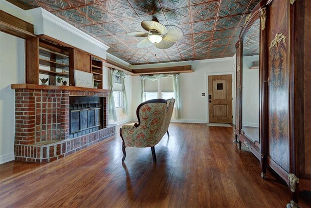 2113 N Gatewood Ave, Oklahoma City, OK 73106 - living area with crown molding, baseboards, ceiling fan, an ornate ceiling, and a brick fireplace