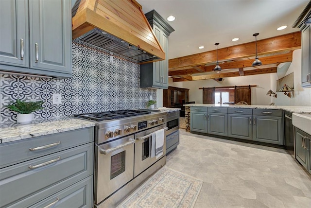2113 N Gatewood Ave, Oklahoma City, OK 73106 - kitchen with range with two ovens, gray cabinets, custom range hood, backsplash, and recessed lighting