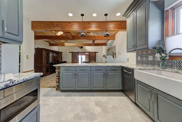 2113 N Gatewood Ave, Oklahoma City, OK 73106 - kitchen featuring gray cabinets, a peninsula, appliances with stainless steel finishes, healthy amount of natural light, and recessed lighting