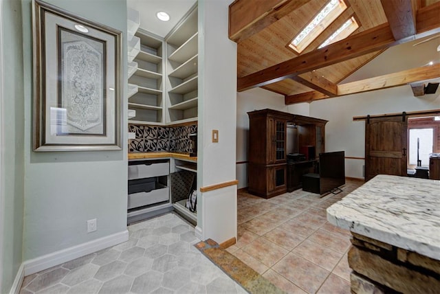 2113 N Gatewood Ave, Oklahoma City, OK 73106 - kitchen featuring a barn door, baseboards, light tile patterned floors, wooden ceiling, and an office area