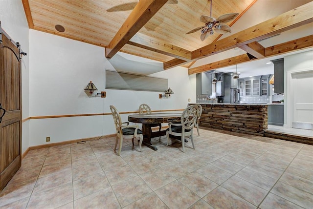2113 N Gatewood Ave, Oklahoma City, OK 73106 - dining room with ceiling fan, light tile patterned flooring, wooden ceiling, a barn door, and baseboards