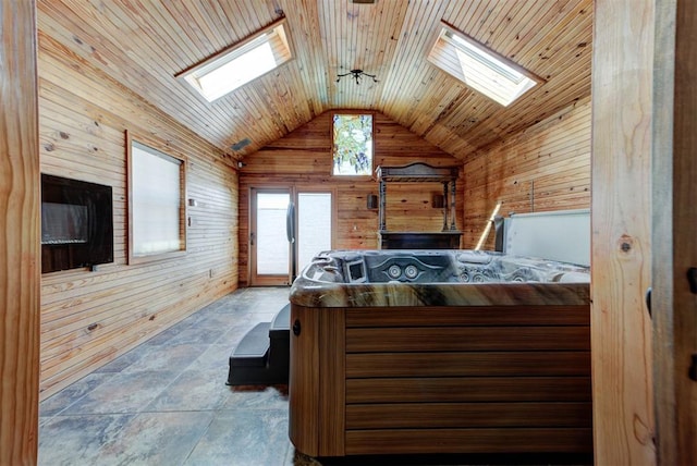 2113 N Gatewood Ave, Oklahoma City, OK 73106 - bedroom with a skylight, wooden walls, vaulted ceiling, access to outside, and stone finish floors