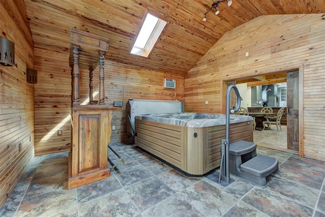 2113 N Gatewood Ave, Oklahoma City, OK 73106 - bedroom with wooden walls, wooden ceiling, high vaulted ceiling, a skylight, and stone tile flooring