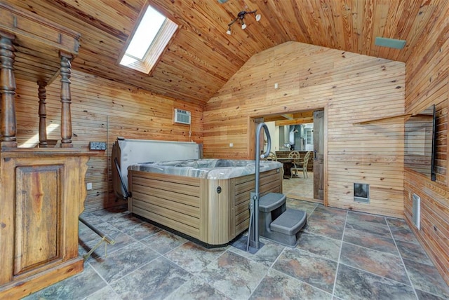 2113 N Gatewood Ave, Oklahoma City, OK 73106 - bedroom featuring wood walls, wood ceiling, high vaulted ceiling, a skylight, and stone finish floors