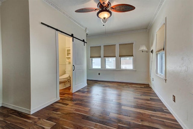 2113 N Gatewood Ave, Oklahoma City, OK 73106 - unfurnished bedroom with a barn door, multiple windows, wood finished floors, crown molding, and ensuite bathroom