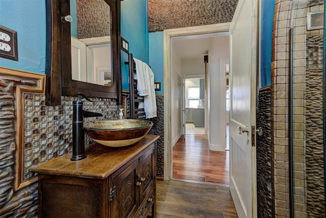 2113 N Gatewood Ave, Oklahoma City, OK 73106 - bathroom featuring wood finished floors, vanity, and decorative backsplash