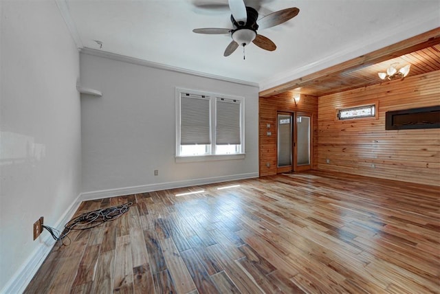 2113 N Gatewood Ave, Oklahoma City, OK 73106 - unfurnished room with wood walls, baseboards, wood finished floors, ceiling fan, and crown molding