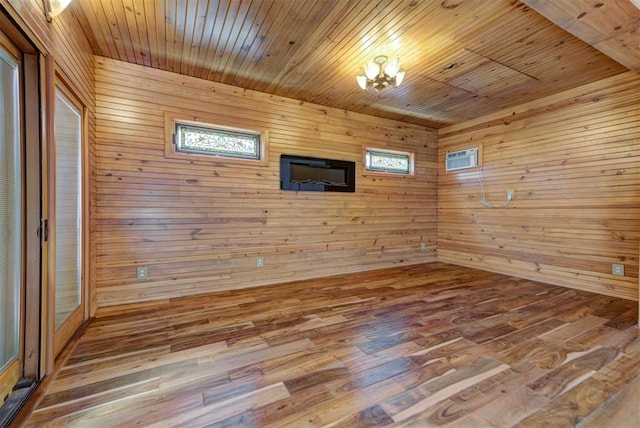 2113 N Gatewood Ave, Oklahoma City, OK 73106 - spare room featuring wooden ceiling, wooden walls, wood finished floors, and a wall mounted air conditioner