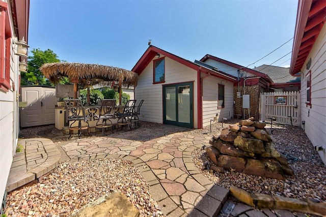 2113 N Gatewood Ave, Oklahoma City, OK 73106 - view of patio / terrace with an outbuilding and outdoor dining space