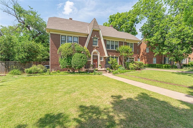 1527 NW 35th St, Oklahoma City, OK 73118 - tudor home featuring a chimney and brick siding