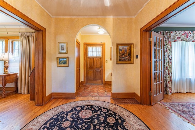 1527 NW 35th St, Oklahoma City, OK 73118 - foyer featuring arched walkways, light wood-style floors, baseboards, and ornamental molding
