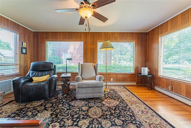 1527 NW 35th St, Oklahoma City, OK 73118 - sitting room featuring ornamental molding, healthy amount of natural light, wood finished floors, a baseboard heating unit, and wood walls