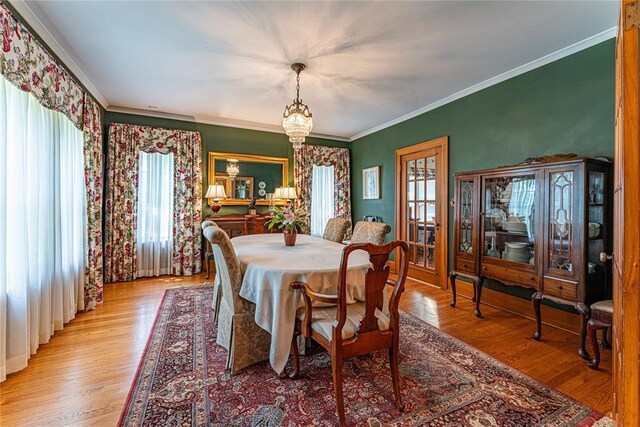 1527 NW 35th St, Oklahoma City, OK 73118 - dining room with ornamental molding, wood finished floors, and a chandelier