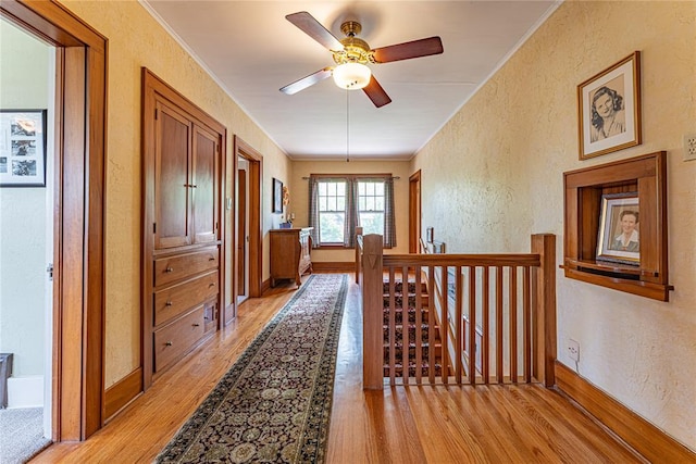 1527 NW 35th St, Oklahoma City, OK 73118 - corridor featuring light wood-type flooring, a textured wall, an upstairs landing, and baseboards