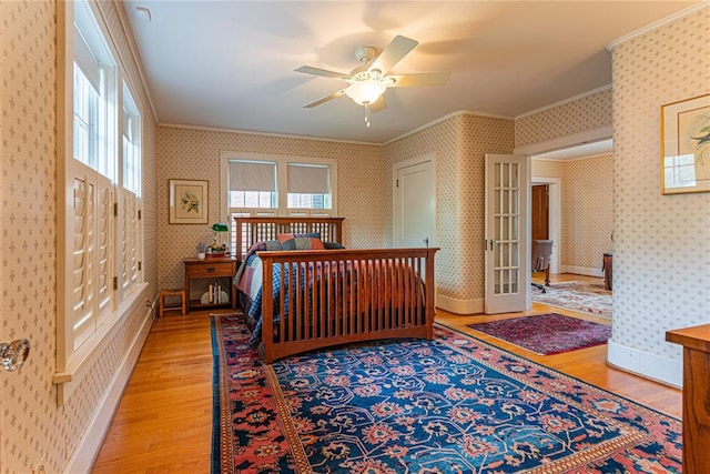 1527 NW 35th St, Oklahoma City, OK 73118 - bedroom featuring crown molding, light wood-type flooring, wallpapered walls, and baseboards