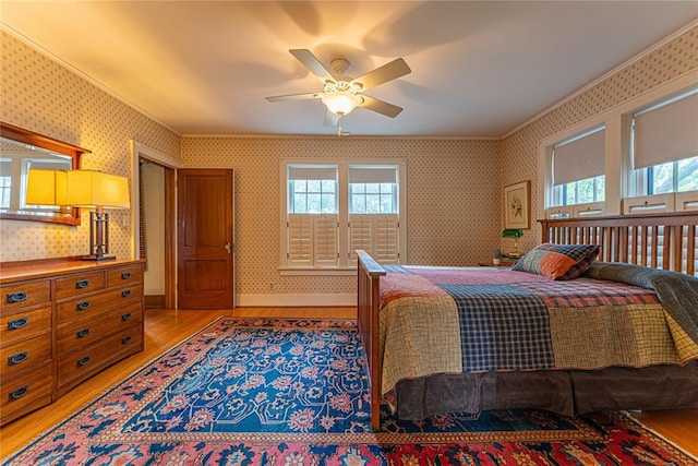 1527 NW 35th St, Oklahoma City, OK 73118 - bedroom with light wood-type flooring, wallpapered walls, multiple windows, a ceiling fan, and crown molding