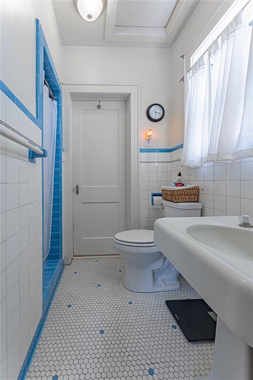 1527 NW 35th St, Oklahoma City, OK 73118 - bathroom with toilet, tile walls, tile patterned flooring, and a shower with shower curtain
