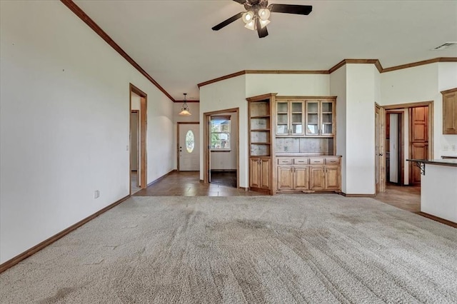 104 Southpointe Ave, Tuttle, OK 73089 - unfurnished living room featuring crown molding, light carpet, ceiling fan, and baseboards