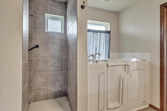 104 Southpointe Ave, Tuttle, OK 73089 - bathroom featuring healthy amount of natural light, a garden tub, and a tile shower