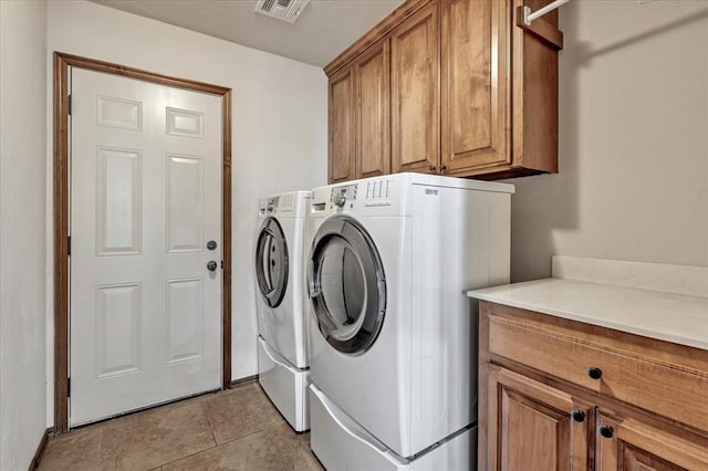 104 Southpointe Ave, Tuttle, OK 73089 - laundry room featuring cabinet space, washer and dryer, light tile patterned floors, and baseboards