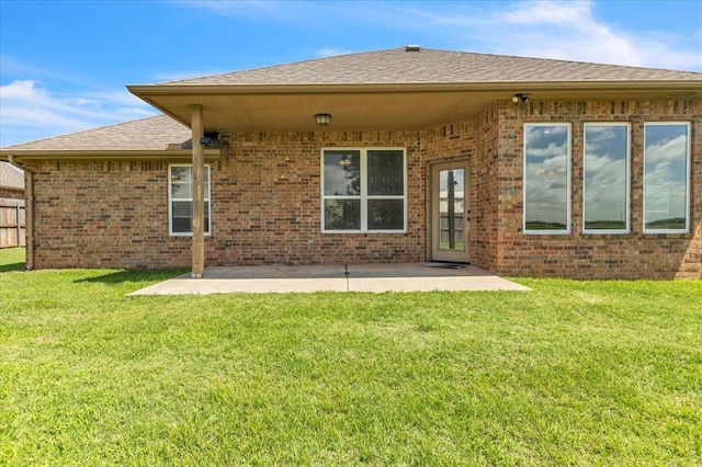 104 Southpointe Ave, Tuttle, OK 73089 - back of property featuring a patio area, a shingled roof, a yard, and brick siding