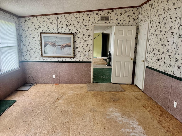 19350 8 A St, Norman, OK 73026 - spare room with wallpapered walls, ornamental molding, and wainscoting