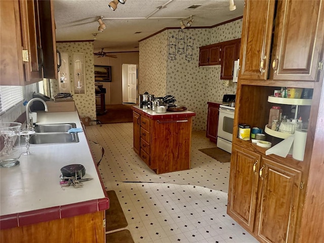 19350 8 A St, Norman, OK 73026 - kitchen with white electric stove, a sink, light flooring, ornamental molding, and wallpapered walls