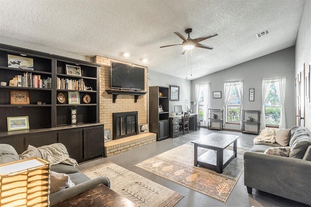829 Douglas Dr, Norman, OK 73069 - living room featuring a textured ceiling, lofted ceiling, a ceiling fan, a brick fireplace, and finished concrete floors