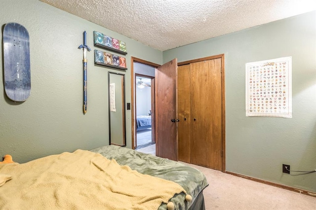 829 Douglas Dr, Norman, OK 73069 - carpeted bedroom featuring a closet, a textured wall, a textured ceiling, and baseboards