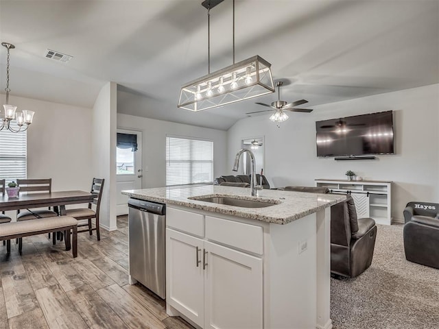 1940 Eli Ave, Tuttle, OK 73089 - kitchen with stainless steel dishwasher, a sink, open floor plan, an island with sink, and light stone countertops