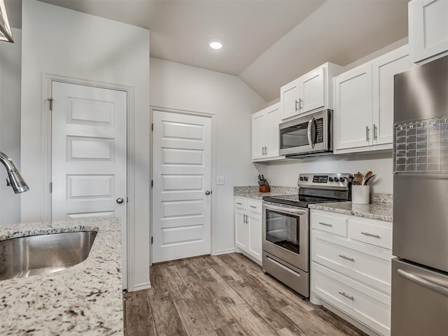 1940 Eli Ave, Tuttle, OK 73089 - kitchen with stainless steel appliances, a sink, dark wood-type flooring, white cabinetry, and recessed lighting