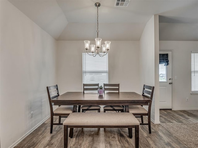 1940 Eli Ave, Tuttle, OK 73089 - dining area featuring a chandelier, wood finished floors, baseboards, and lofted ceiling