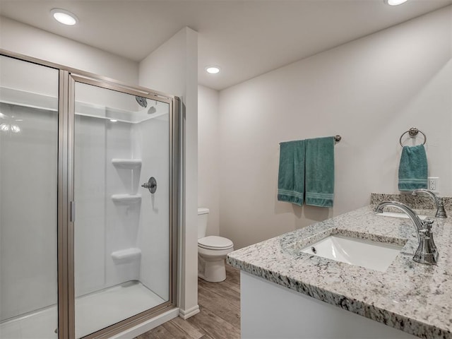 1940 Eli Ave, Tuttle, OK 73089 - bathroom with vanity, a shower stall, wood finished floors, and recessed lighting