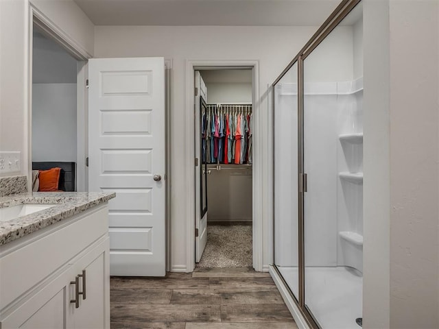 1940 Eli Ave, Tuttle, OK 73089 - full bath with wood finished floors, vanity, a stall shower, and a spacious closet
