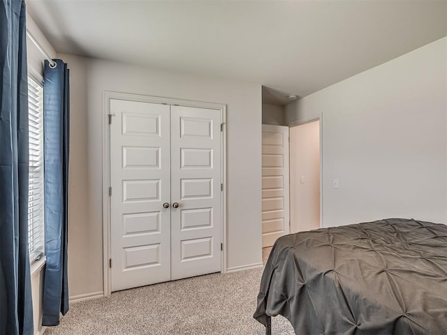 1940 Eli Ave, Tuttle, OK 73089 - bedroom with light colored carpet, a closet, and baseboards