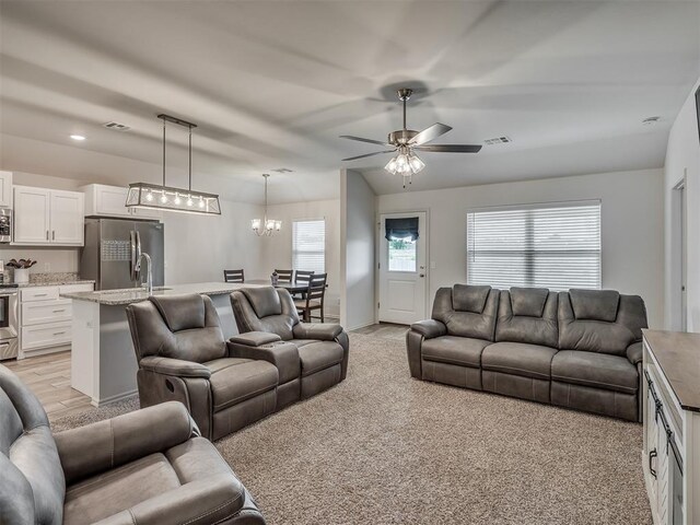 1940 Eli Ave, Tuttle, OK 73089 - living room with a chandelier, ceiling fan, light carpet, and baseboards