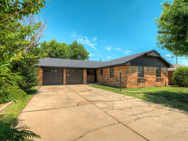 2117 SW 76th St, Oklahoma City, OK 73159 - single story home with a garage, brick siding, driveway, and a front lawn
