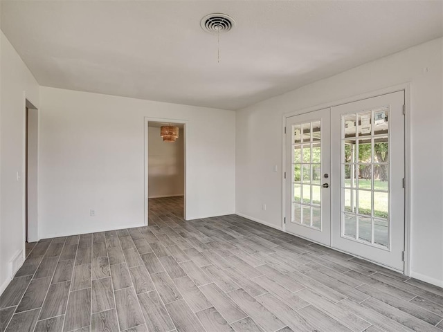 2117 SW 76th St, Oklahoma City, OK 73159 - empty room featuring wood finished floors and french doors