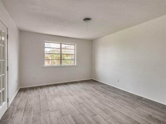 2117 SW 76th St, Oklahoma City, OK 73159 - spare room with wood finished floors and baseboards