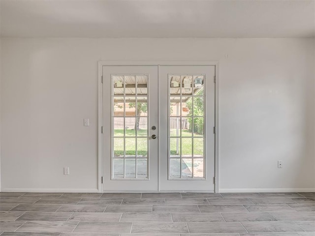 2117 SW 76th St, Oklahoma City, OK 73159 - entryway with french doors, wood finish floors, and baseboards