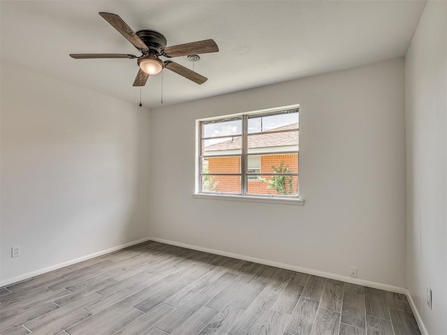 2117 SW 76th St, Oklahoma City, OK 73159 - unfurnished room with wood finished floors, baseboards, and a ceiling fan