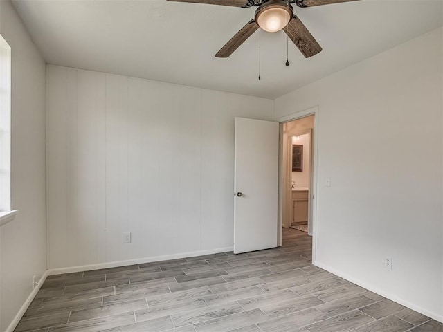 2117 SW 76th St, Oklahoma City, OK 73159 - empty room featuring wood finished floors, ceiling fan, and baseboards