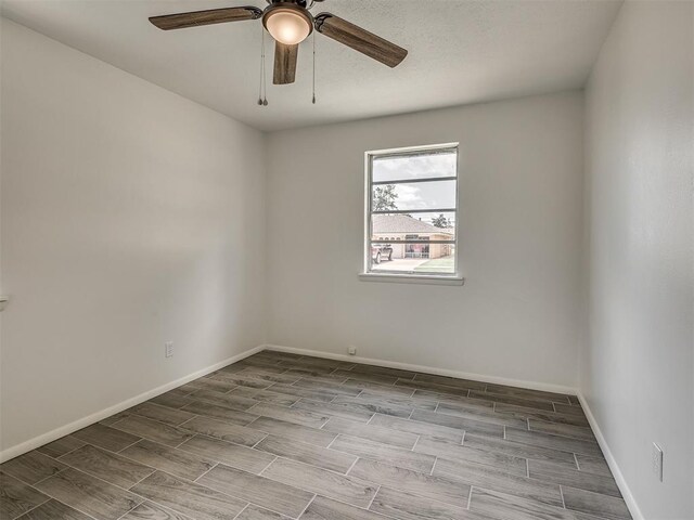 2117 SW 76th St, Oklahoma City, OK 73159 - unfurnished room featuring wood finish floors, a ceiling fan, and baseboards