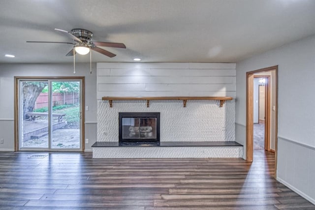 1439 Greenbriar Dr, Norman, OK 73072 - unfurnished living room featuring wood finished floors, a ceiling fan, a glass covered fireplace, and baseboards