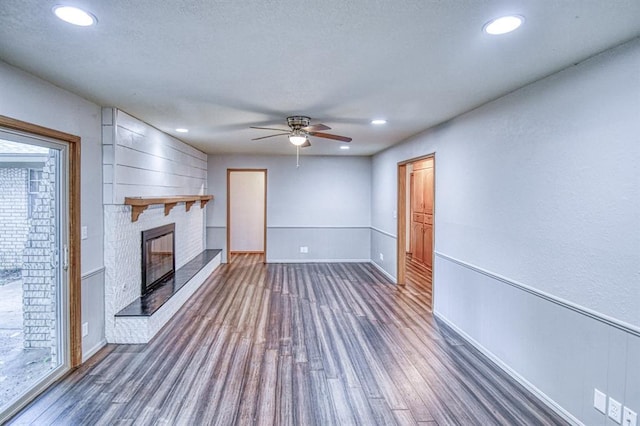 1439 Greenbriar Dr, Norman, OK 73072 - unfurnished living room featuring wood finished floors, a brick fireplace, ceiling fan, recessed lighting, and baseboards