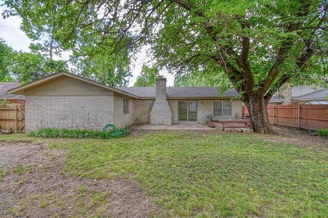 1439 Greenbriar Dr, Norman, OK 73072 - rear view of property featuring a chimney, brick siding, and a patio area