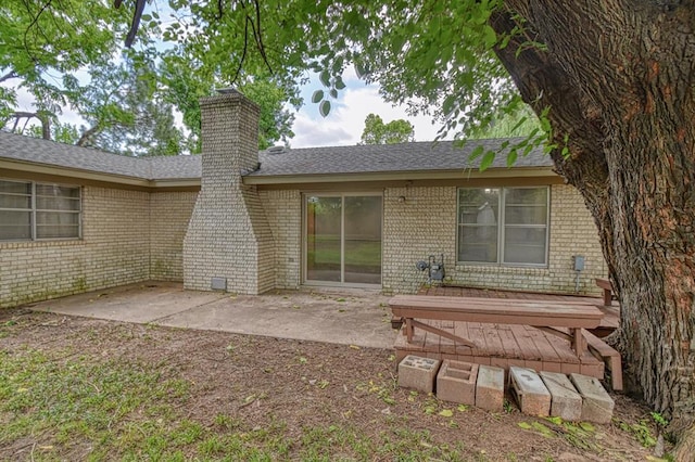 1439 Greenbriar Dr, Norman, OK 73072 - rear view of property featuring brick siding, a chimney, and a patio