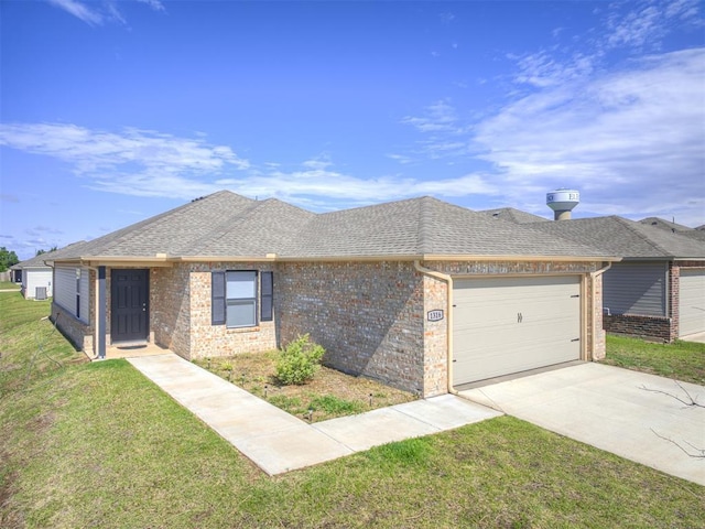 1316 Chuck Wagon Dr, El Reno, OK 73036 - view of front of house featuring an attached garage, brick siding, and driveway