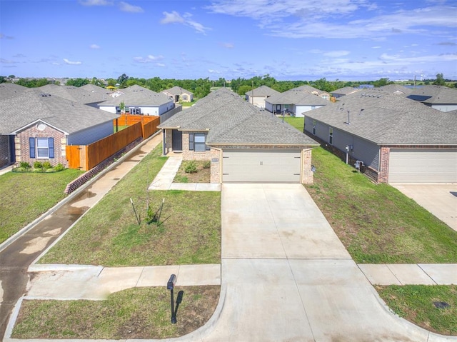 1316 Chuck Wagon Dr, El Reno, OK 73036 - view of front of home with brick siding, a residential view, driveway, and an attached garage